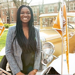 girl posing in front of ramblin wreck