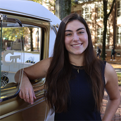 girl posing in front of ramblin wreck