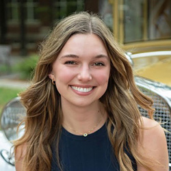 girl posing in front of ramblin wreck